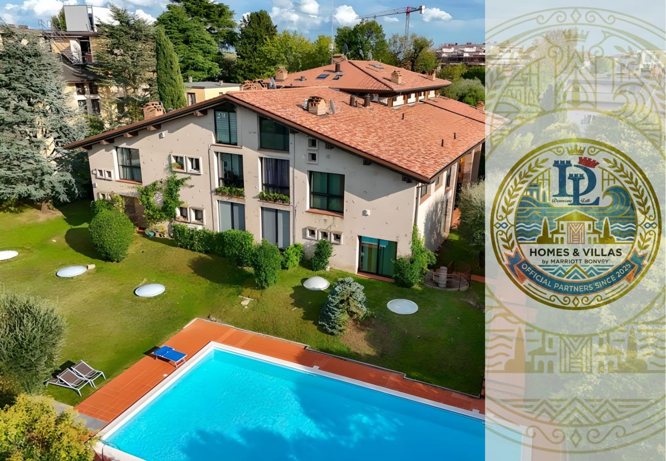 Vista della piscina condominiale circondata dal verde a Swarovski